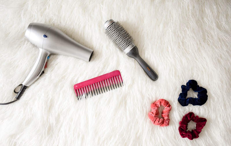 grey-hair-blower-near-pink-hair-combs-and-scrunchies